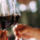 Couple cheering with glasses of red wine