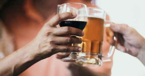 anstoßen mit einem glas wein und einem glas bier