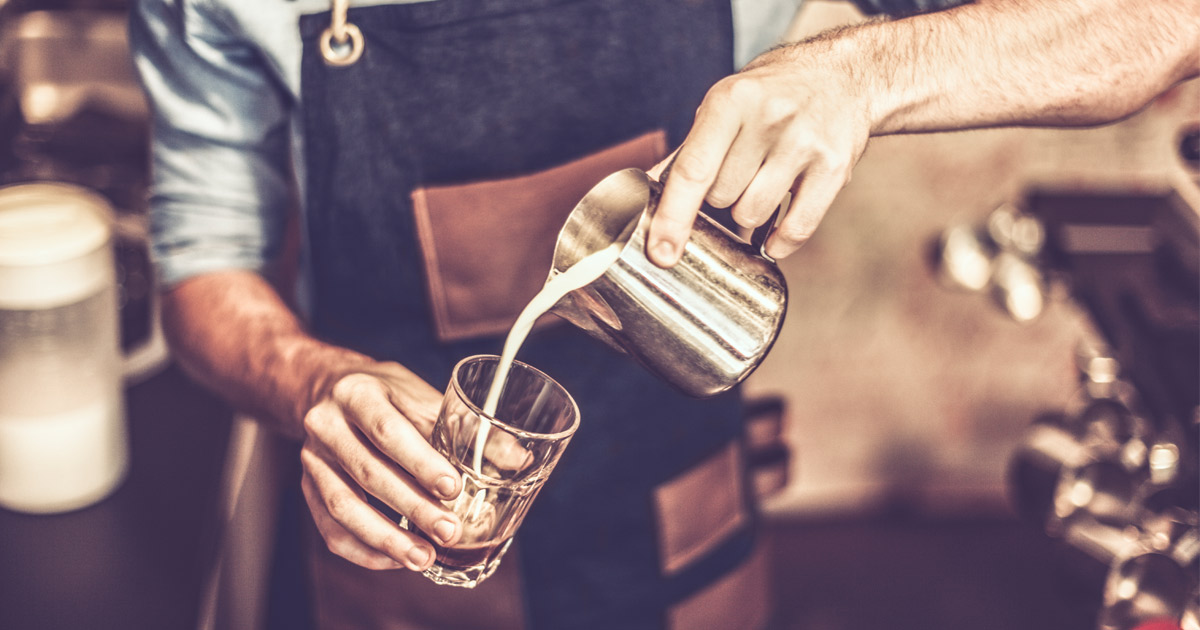 Young barista is making a coffee